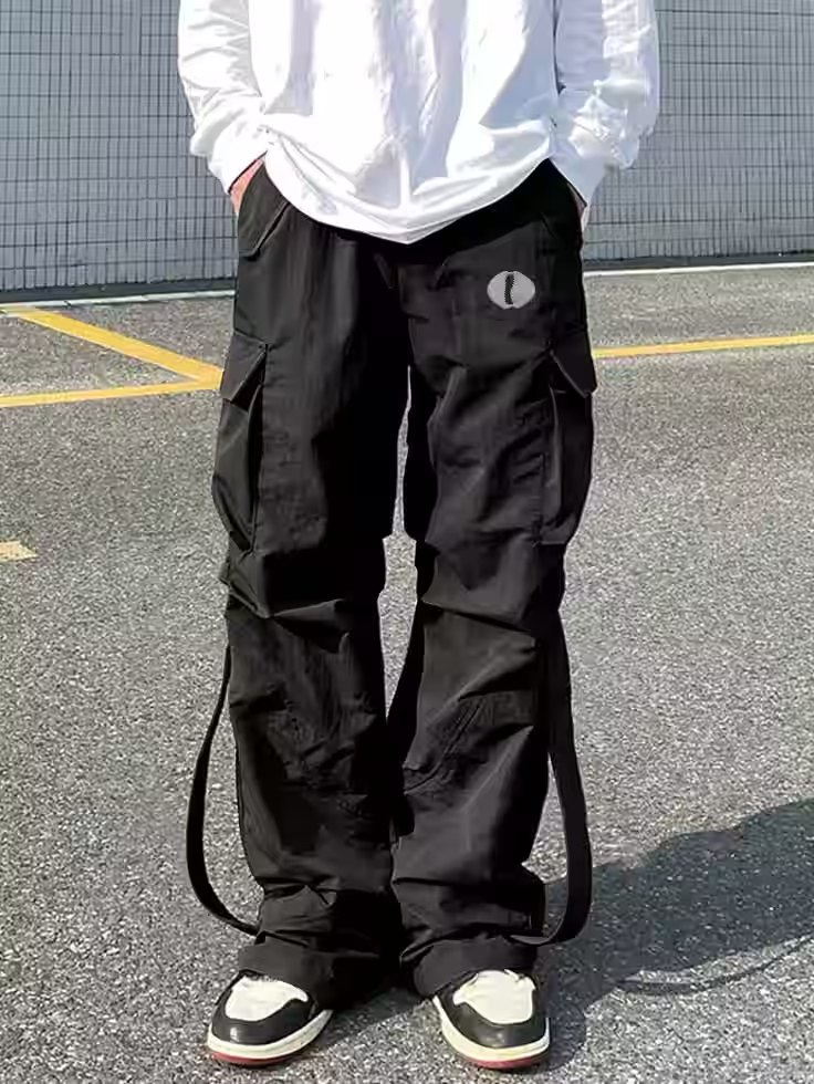 Black wide-leg cargo pants worn with sneakers