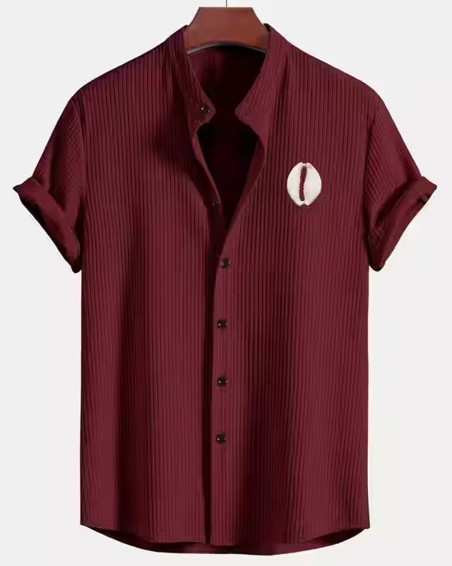 Burgundy short-sleeve ribbed button-up shirt with a white cowrie emblem on the chest